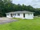 Inviting single-story home showcasing blue shutters, grassy lawn and a paved driveway at 410 S Gordon Sw Rd, Mableton, GA 30126