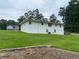 Exterior of the home, with a spacious green lawn and a view of the surrounding landscape at 410 S Gordon Sw Rd, Mableton, GA 30126