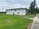 Two story home exterior with a white facade, spacious yard, and concrete path at 410 S Gordon Sw Rd, Mableton, GA 30126