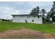 View of exterior with white facade, spacious lawn, and street access at 410 S Gordon Sw Rd, Mableton, GA 30126