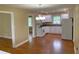 Open-concept kitchen with white cabinets, hardwood floors, and modern lighting at 410 S Gordon Sw Rd, Mableton, GA 30126