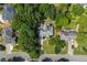 Aerial view of neighborhood with mature landscaping showcasing the home's location and backyard at 10880 Windham Way, Alpharetta, GA 30022