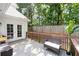 Backyard deck area showcasing a cozy bench, lush greenery, and access to the house at 10880 Windham Way, Alpharetta, GA 30022