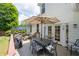 Outdoor wooden deck area showcasing a dining table with a shade umbrella and outdoor chairs at 10880 Windham Way, Alpharetta, GA 30022
