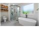 Modern bathroom features a freestanding tub, glass shower, and stylish tile flooring at 10880 Windham Way, Alpharetta, GA 30022
