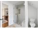 Bright bathroom showcasing glass shower and adjacent toilet in a modern, clean design at 10880 Windham Way, Alpharetta, GA 30022