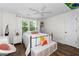 Cozy bedroom features a comfortable bed, ceiling fan, and bright natural light from the windows at 10880 Windham Way, Alpharetta, GA 30022