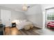 Cozy bedroom with daybed, hardwood floors, and natural light from a large window at 10880 Windham Way, Alpharetta, GA 30022