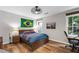 Comfortable bedroom with hardwood floors, a desk area, and good natural light at 10880 Windham Way, Alpharetta, GA 30022