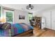 Bedroom with neutral paint, wood floors, a ceiling fan, and lots of natural light at 10880 Windham Way, Alpharetta, GA 30022