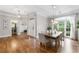 Open dining area with hardwood floors and natural light that showcase the adjacent living spaces at 10880 Windham Way, Alpharetta, GA 30022