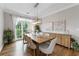 Elegant dining room with hardwood floors and a modern chandelier over a wooden dining table at 10880 Windham Way, Alpharetta, GA 30022