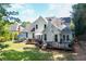 Spacious white home with a large deck, chimney, and lush green lawn at 10880 Windham Way, Alpharetta, GA 30022
