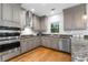 Modern kitchen featuring granite countertops, stainless steel appliances, and ample cabinet space at 10880 Windham Way, Alpharetta, GA 30022