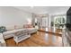 Spacious living room with hardwood floors, comfortable seating, and seamless flow to other living areas at 10880 Windham Way, Alpharetta, GA 30022