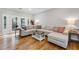 Cozy living room featuring a large sectional sofa, French doors, and hardwood floors at 10880 Windham Way, Alpharetta, GA 30022
