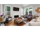 Open living room with vaulted ceiling, fireplace, and hardwood floors at 10880 Windham Way, Alpharetta, GA 30022