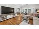 Open living room featuring hardwood floors, a large TV, and comfortable seating in neutral tones at 10880 Windham Way, Alpharetta, GA 30022
