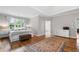 Spacious main bedroom with hardwood floors, tray ceiling, and a large window providing natural light at 10880 Windham Way, Alpharetta, GA 30022