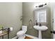 Stylish powder room featuring a pedestal sink, modern fixtures, and decorative accents at 10880 Windham Way, Alpharetta, GA 30022