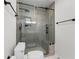 Contemporary shower features glass door, bench, unique tiling, and matte black fixtures at 10880 Windham Way, Alpharetta, GA 30022