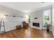 Bright sitting room with hardwood floors, neutral walls, and a cozy fireplace at 10880 Windham Way, Alpharetta, GA 30022