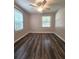 Bedroom featuring wood-look floors, white trim and two windows with white blinds at 1341 Se Joyner Se Ave, Marietta, GA 30060
