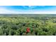 An aerial view of the home with a location pin amidst lush green trees, skyline in the distance at 620 Amberidge Trl, Atlanta, GA 30328
