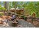 Backyard with stone paver patio featuring a fire pit and outdoor seating area at 620 Amberidge Trl, Atlanta, GA 30328