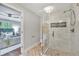 Modern bathroom featuring a glass door shower with stone pebble floor and light herringbone tile at 620 Amberidge Trl, Atlanta, GA 30328