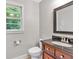 Cozy bathroom featuring a granite countertop, warm vanity and window view at 620 Amberidge Trl, Atlanta, GA 30328