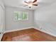 Bright bedroom featuring hardwood floors, a ceiling fan, and a window with natural light at 620 Amberidge Trl, Atlanta, GA 30328