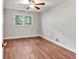 Bright bedroom with hardwood floors, ceiling fan, and a window offering natural light at 620 Amberidge Trl, Atlanta, GA 30328