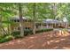 Charming brick home with covered porch, carport, and beautifully landscaped front yard with mature trees at 620 Amberidge Trl, Atlanta, GA 30328