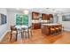 Bright eat-in kitchen boasts wood cabinets, stainless appliances, pendant lighting, and island with bar seating at 620 Amberidge Trl, Atlanta, GA 30328
