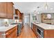 Modern kitchen features stainless appliances, stone countertops, wood cabinets, and accent wall at 620 Amberidge Trl, Atlanta, GA 30328