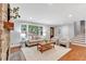 Spacious living room with a stone fireplace, hardwood floors, and abundant natural light at 620 Amberidge Trl, Atlanta, GA 30328