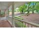Inviting covered front porch with classic white railing and brick flooring offering scenic views at 620 Amberidge Trl, Atlanta, GA 30328
