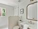 Bright bathroom featuring glass shower, framed mirror, and stylish vanity with marble countertop at 2973 Payton Ne Rd, Atlanta, GA 30345