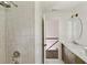 Bathroom with shower, marble counters, and a glimpse of the staircase beyond the door at 2973 Payton Ne Rd, Atlanta, GA 30345