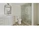 Bathroom featuring vanity, glass shower, patterned tile floor, and natural light from the window at 2973 Payton Ne Rd, Atlanta, GA 30345