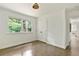 Bedroom with hardwood flooring, and large window offering lush green view and white closet doors at 2973 Payton Ne Rd, Atlanta, GA 30345