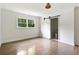 Bright bedroom with hardwood floors, white trim, and a sliding door to the en-suite bathroom at 2973 Payton Ne Rd, Atlanta, GA 30345