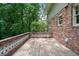 A spacious wooden deck surrounded by brick walls, greenery, and trees, creating a serene outdoor space at 2973 Payton Ne Rd, Atlanta, GA 30345