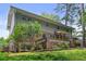 Exterior view of a two-story brick and siding home surrounded by mature trees and lush landscaping at 2973 Payton Ne Rd, Atlanta, GA 30345