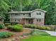 Charming home with a landscaped front yard, brick accents, and surrounded by lush greenery and mature trees at 2973 Payton Ne Rd, Atlanta, GA 30345