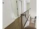 Hallway with hardwood floors and stairs leading to rooms with white doors at 2973 Payton Ne Rd, Atlanta, GA 30345