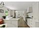 Open-concept kitchen showcases white cabinetry, stainless steel appliances, and wood floors at 2973 Payton Ne Rd, Atlanta, GA 30345