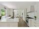 Bright kitchen with stainless steel appliances, white cabinetry, and access to living area at 2973 Payton Ne Rd, Atlanta, GA 30345