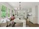Bright eat-in kitchen features a breakfast nook, a round table, and white cabinetry at 2973 Payton Ne Rd, Atlanta, GA 30345